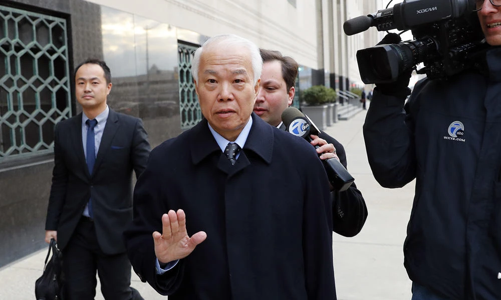 Takata Corp.'s chief financial officer Yoichiro Nomura leaves federal court in Detroit on Monday. Japanese auto parts maker Takata Corp. pleaded guilty to fraud Monday and agreed to pay $1 billion in penalties for concealing an air bag defect blamed for at least 16 deaths, most of them in the US. (AP Photo/Paul Sancya)