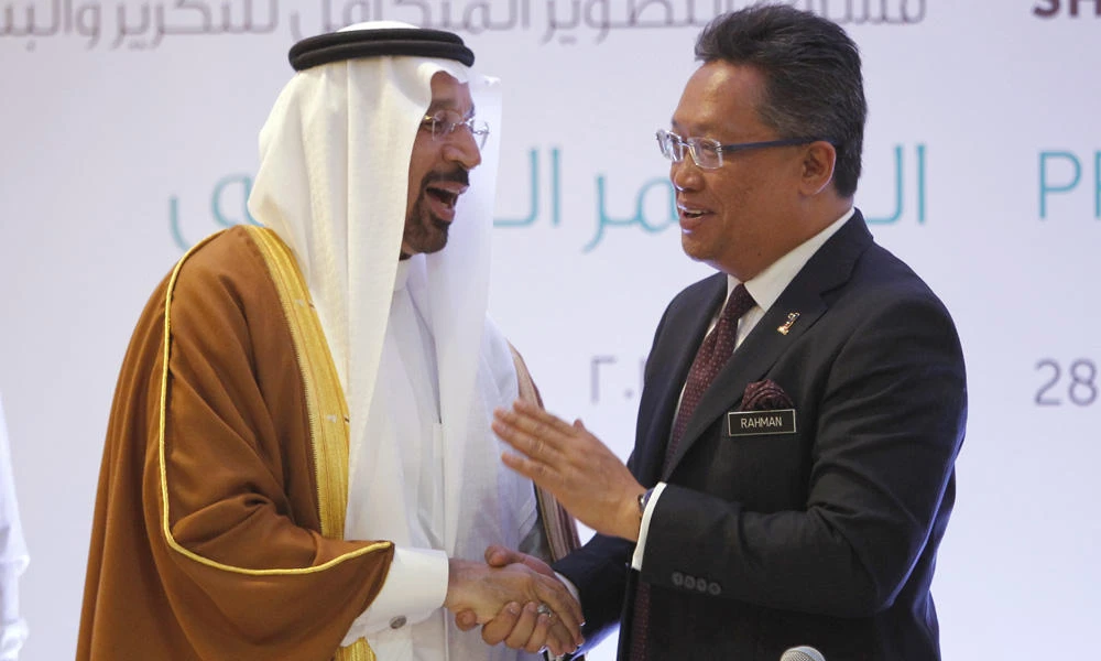 Saudi Energy Minister Khalid Al-Falih, left, shakes hands with Malaysia's Minister in the Prime Minister's Department Abdul Rahman Dahlan during a press conference at a hotel in Kuala Lumpur, Malaysia, on Tuesday. Saudi Arabia and Malaysia signed four major agreements Monday that will go a long way in cementing ties between the two countries. (AP Photo/Daniel Chan)