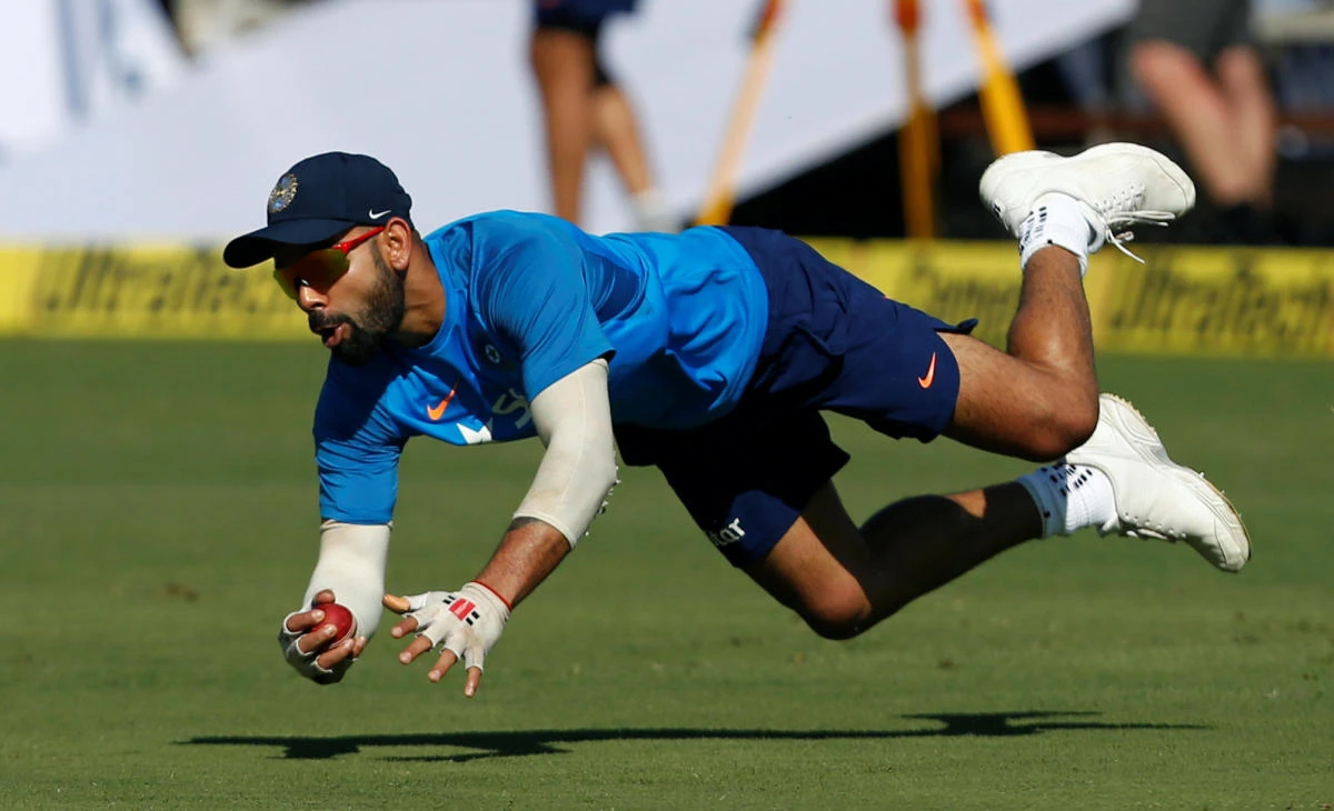 India's captain Virat Kohli dives to catch the ball during a practice session ahead of their second Test cricket match. (Reuters)