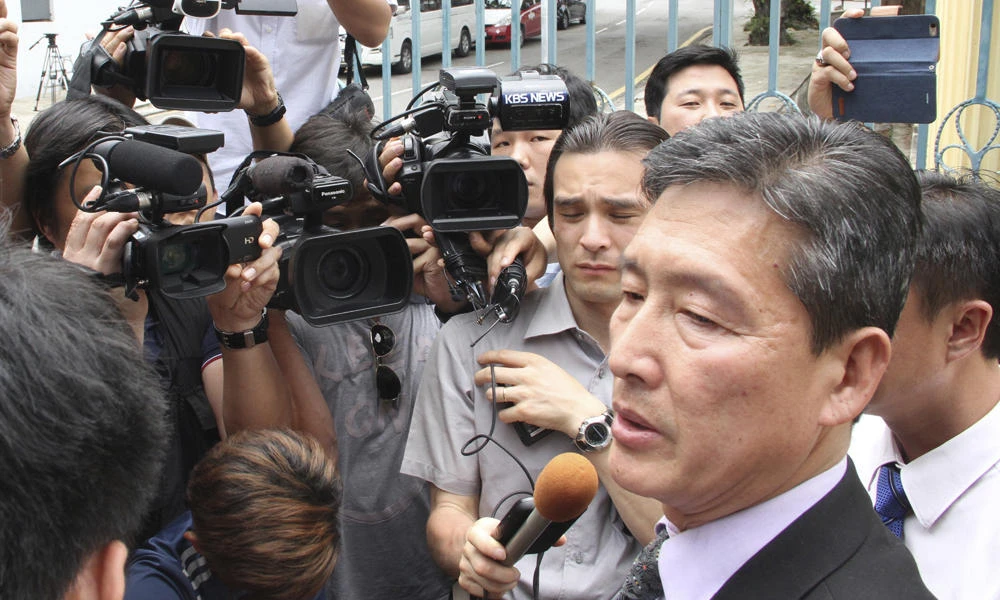 Ri Tong Il, former North Korean deputy ambassador to the United Nations, speaks to reporters outside the North Korean embassy in Kuala Lumpur, Malaysia, on Tuesday. Ri told reporters Tuesday that North Korea has sent a high-level delegation to Malaysia to seek the return of the body of leader's Kim Jong Un's slain half brother and the release of a North Korean arrested in the case. (AP Photo)