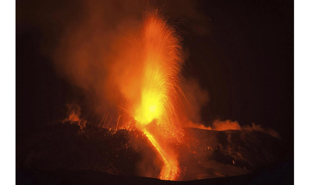 Mount Etna, Europe's most active volcano, spews lava during an eruption, near the Sicilian town of Catania, southern Italy, early Tuesday. (AP Photo/Salvatore Allegra)