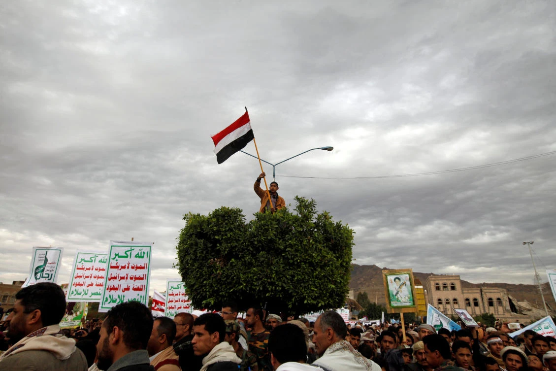 A boy holds a flag as supporters of the Houthi movement attend a pro-Houthi rally in Sanaa, Yemen Feb. 17. (Reuters Photo)