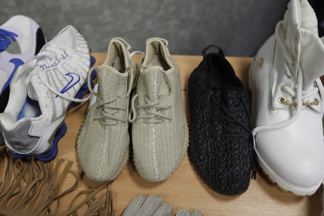 Seized counterfeit footwear, including copies of Adidas and Kanye West Yeezy Boost trainers. (AP)