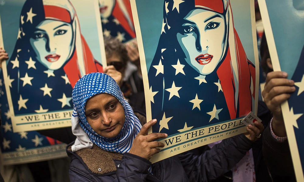 Protesters demonstrate in New York's Times Square against President Donald Trump's executive order banning travel from seven Muslim-majority nations on Feb. 19, 2017. Iraq will be removed from the list of countries covered in the ban, according to Trump officials. (AP Photo/Andres Kudacki)