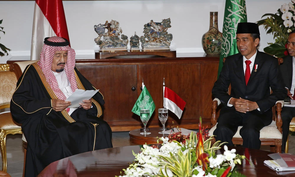King Salman reads a statement as Indonesia's President Joko Widodo looks on at the presidential palace in Bogor, West Java, Indonesia, on Wednesday. (Adi Weda, Pool Photo via AP)