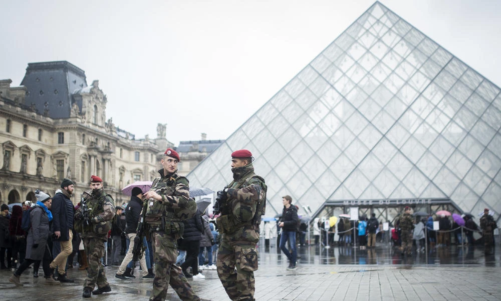A French soldier patrols in the courtyard of the Louvre museum with the visitor control in background in Paris on Saturday. (AP Photo/Kamil Zihnioglu)