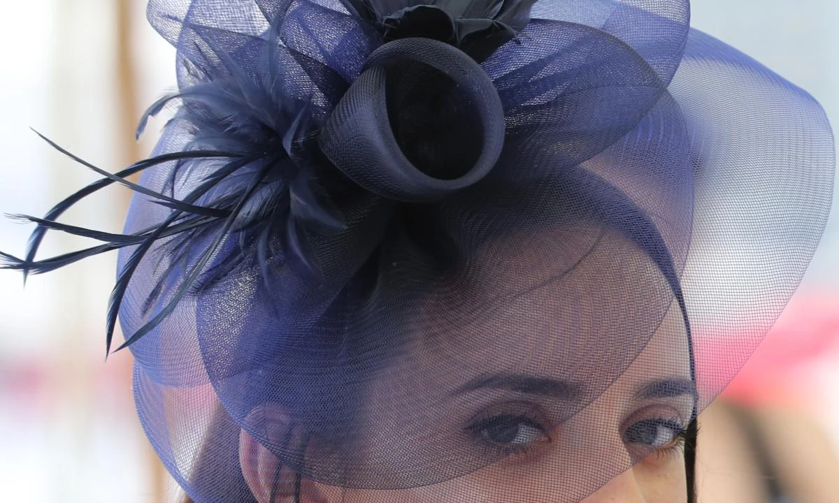 A guest wearing a hat arrives at the Meydan Racecourse to attend the Dubai World Cup day horse racing event Dubai. (AFP)