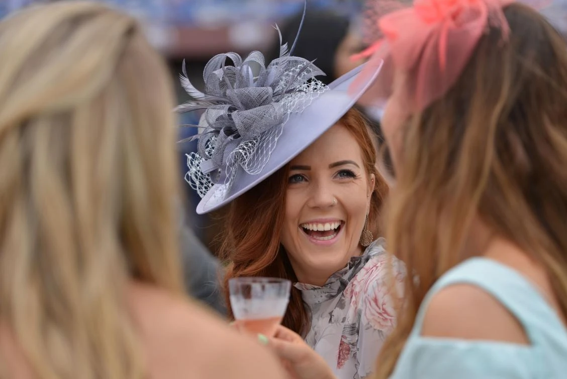 A guest wearing a hat arrives at the Meydan Racecourse to attend the Dubai World Cup day horse racing event, Dubai. (AFP)