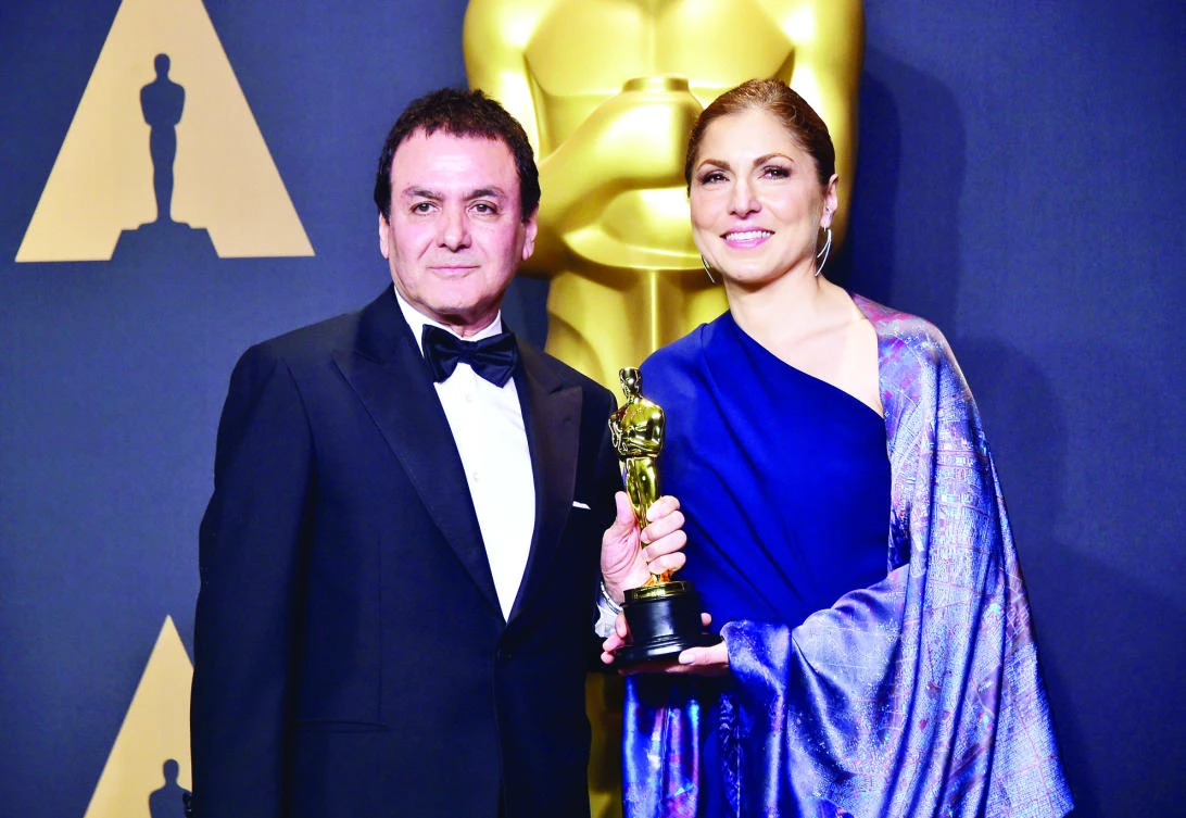 Former NASA scientist Firouz Naderi, left, and astronaut Anousheh Ansari pose with the best foreign-language film award for “The Salesman” on behalf of director Asghar Farhadi. (AFP)
