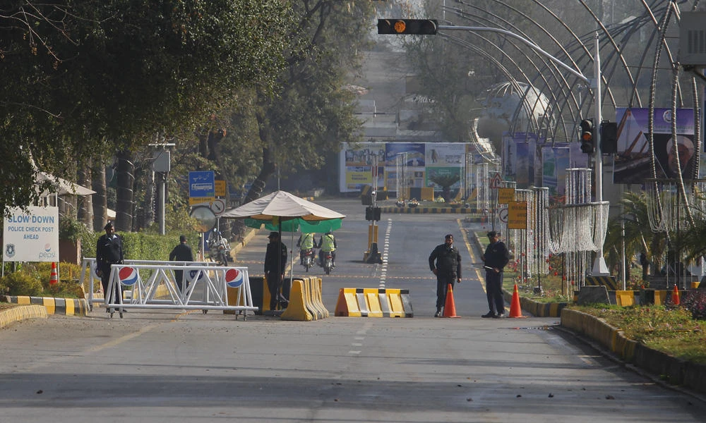 Pakistani army soldiers stand guard at a barricaded road leading to the venue of the Economic Cooperation Organization summit in Islamabad on Wednesday. (AP Photo/Anjum Naveed)