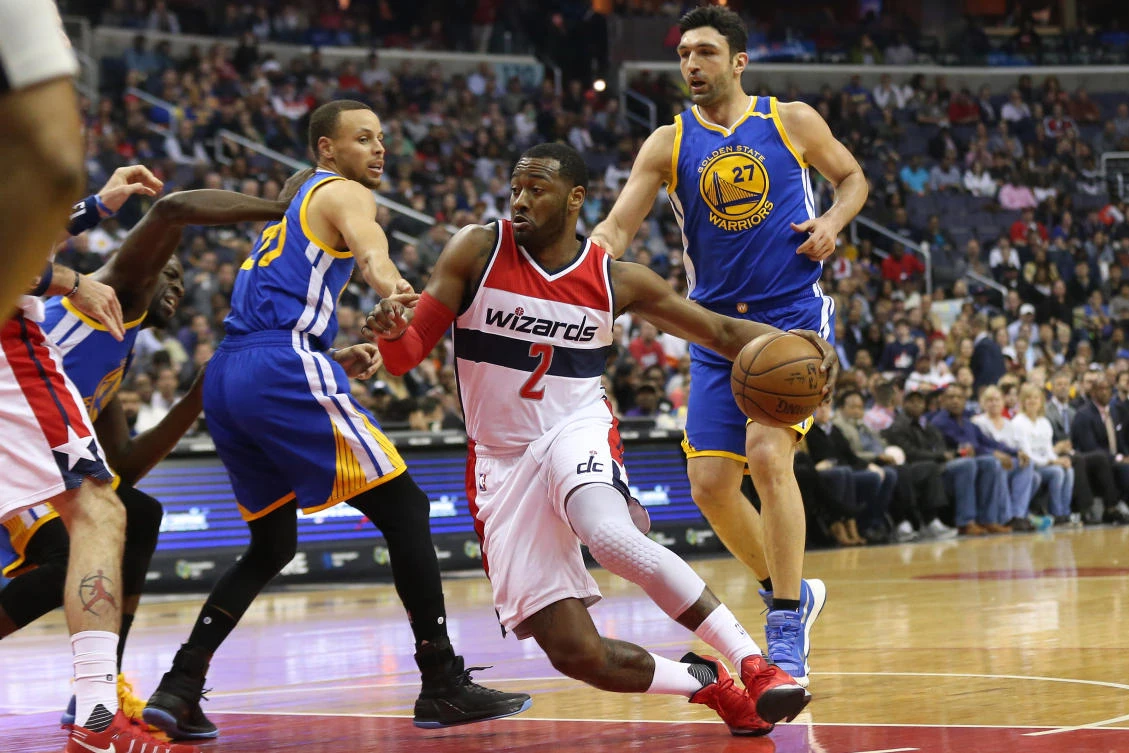 Washington Wizards guard John Wall (2) dribbles the ball past Golden State Warriors guard Stephen Curry (30) in the second quarter at Verizon Center on Tuesday night. (USA TODAY Sports)
