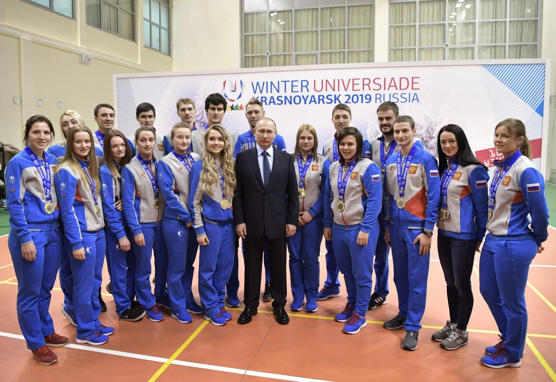 President Vladimir Putin, center, with winners of the last Universiade in Astana, Kazakhstan, during a visit to the Academy of Biathlon in Krasnoyarsk, Russia on Wednesday. (AP)
