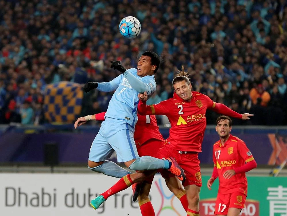 Roger Beyker Martinez, left, of China's Jiangsu FC fights for the ball with Michael Marrone of Australia's Adelaide United during their AFC Champions League group stage football match in Nanjing, east China's Jiangsu province on Wednesday. (AFP)