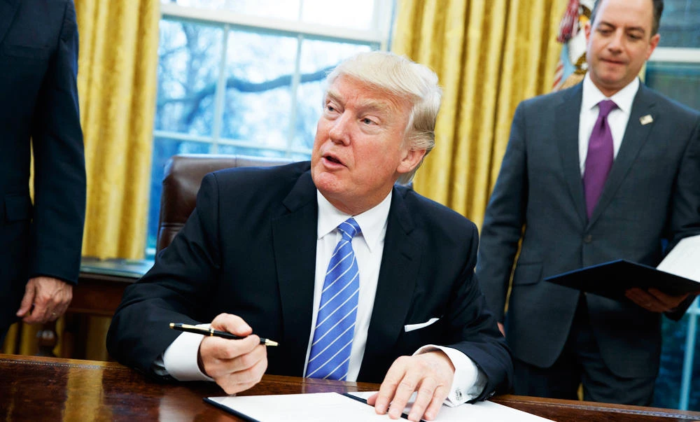 In this Jan. 23, 2017, photo, President Donald Trump signs an executive order to withdraw the U.S. from the Trans-Pacific Partnership trade pact agreed to under the Obama administration, in the Oval Office of the White House in Washington. (AP)