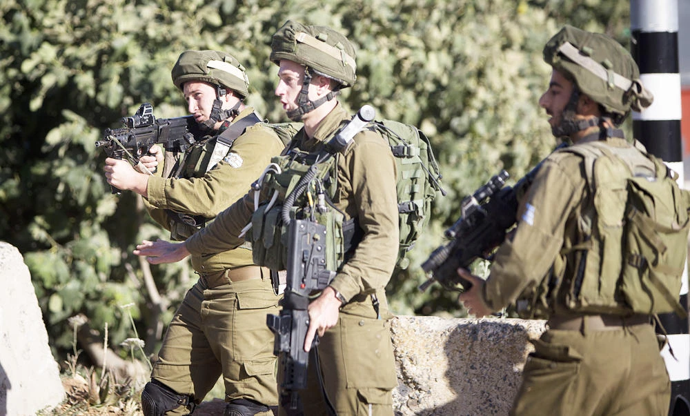 Israeli soldiers stand at a checkpoint near the West Bank city of Nablus, in this June 10, 2016 file photo. (AP)