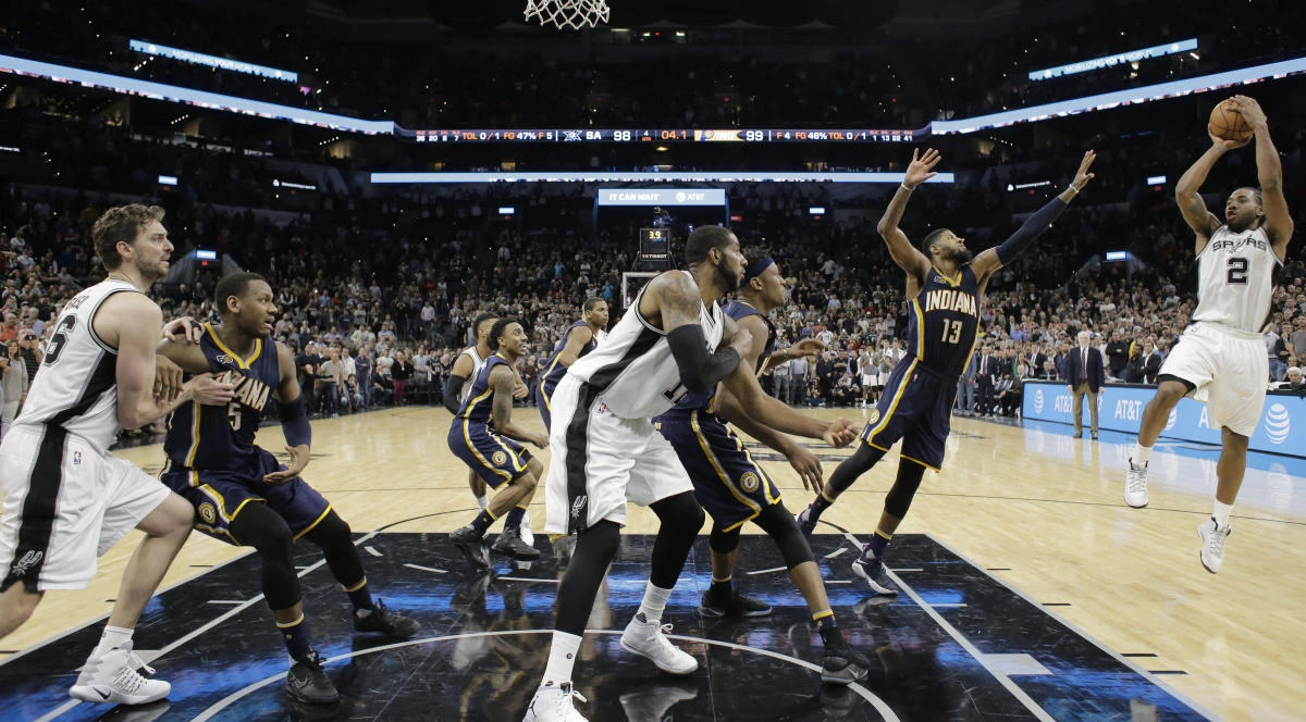 San Antonio Spurs forward Kawhi Leonard (2) shoots and scores over Indiana Pacers forward Paul George (13) in the final seconds of an NBA basketball game in San Antonio on Wednesday night. (AP)