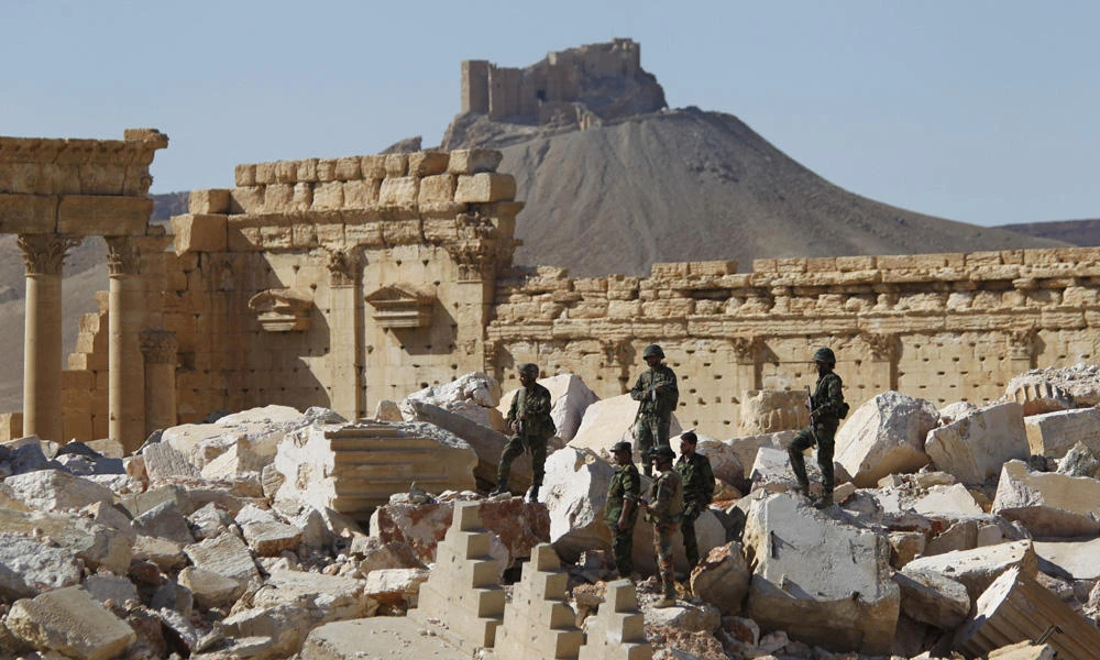 Syrian army soldiers stand on the ruins of the Temple of Bel in the historic city of Palmyra, in Homs governorate, Syria, on April 1, 2016, after driving out Daesh militants. (REUTERS/Omar Sanadiki/File Photo)