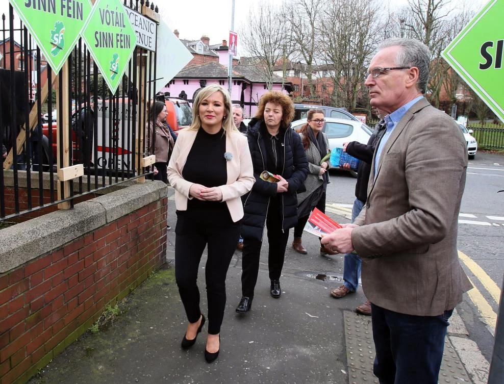 Sinn Fein's Northern leader Michelle O'Neill, left, canvases in Belfast, Northern Ireland on Feb. 22. (AFP Photo)