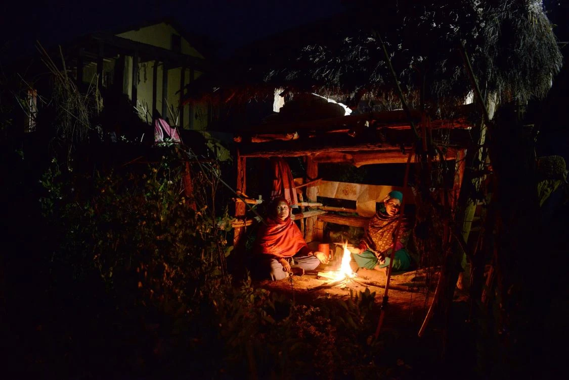 Nepalese women sit by a fire as they live in a Chhaupadi hut during their menstruation period in Surkhet District, west of Kathmandu. ( AFP)