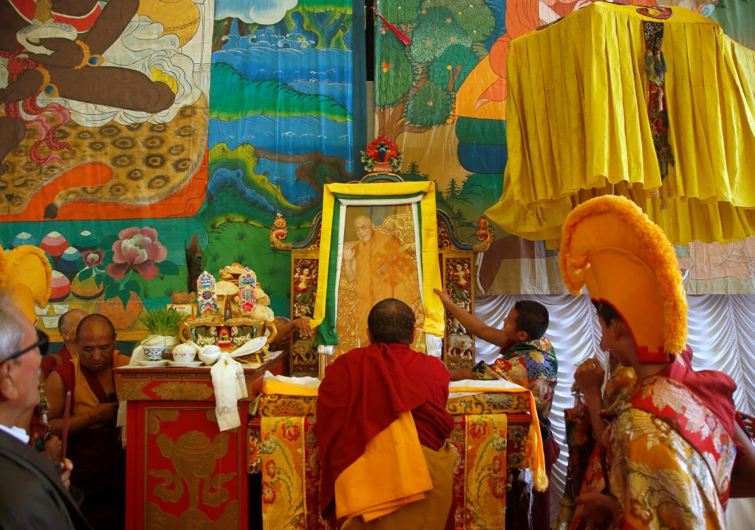 Tibetan monks arrange the portrait of exiled Tibetan spiritual leader, the Dalai Lama, during a function organized to mark “Losar,” or the Tibetan New Year, in Katmandu, Nepal. (REUTERS)
