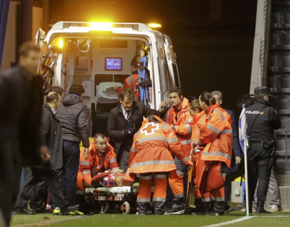 Paramedics take Atletico Madrid's Fernando Torres to a waiting ambulance Thursday night. (Reuters