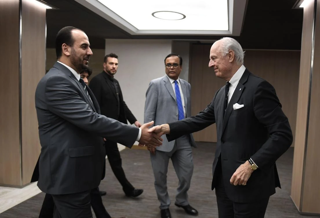 UN Special Envoy of the Secretary-General for Syria Staffan de Mistura (R) shakes hand with Syria’s main opposition High Negotiations Committee (HNC) leader Nasr Al-Hariri. (AFP)