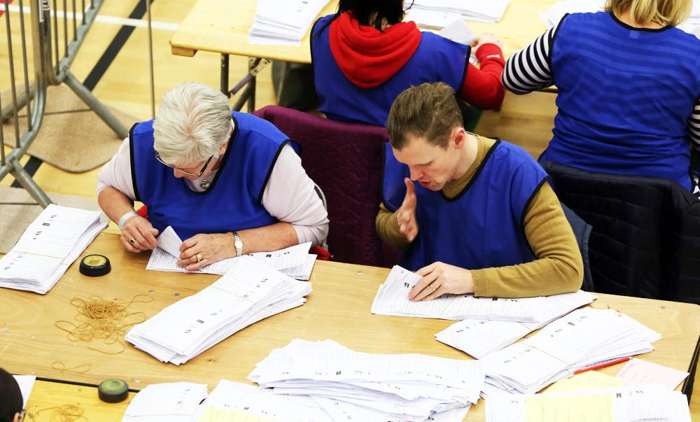 Ballots for the Northern Ireland Assembly elections are counted by count at the count centre in Omagh, Co Tyrone, Northern Ireland, on Friday. (AFP)