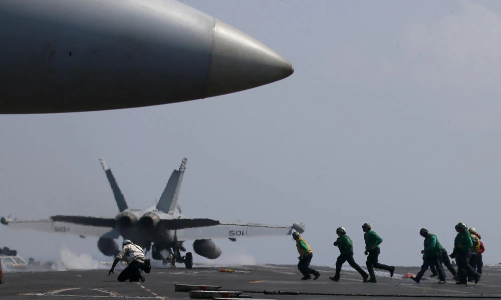 Top Philippine officials fly to US carrier in disputed sea