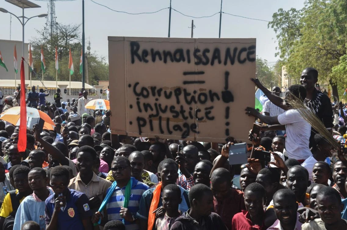 Members of the Niger Front for the restoration of Democracy and the defense of the Republic, hold a placard reading “Rebirth, corruption, injustice, looting” as they take part in a march, in Niamey, on March 4, 2017, to protest against the regime of Niger’s President. (AFP)