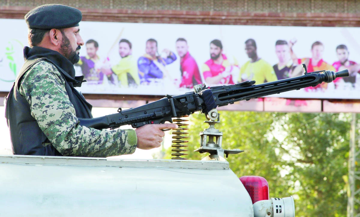 A Pakistani paramilitary soldier stands alert on a vehicle while monitoring the area to ensure security at an entry gate of Qaddafi stadium for the final match of the Pakistan Super League, in Lahore, on Saturday. (AP)