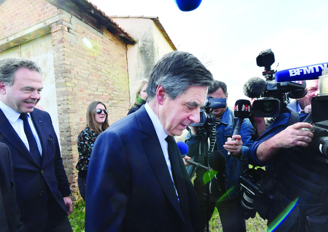French presidential election candidate for the right-wing Les Republicains party Francois Fillon, center, and Luc Chatel, left, visits a farm near Nimes, souhern France on Friday. (AFP)