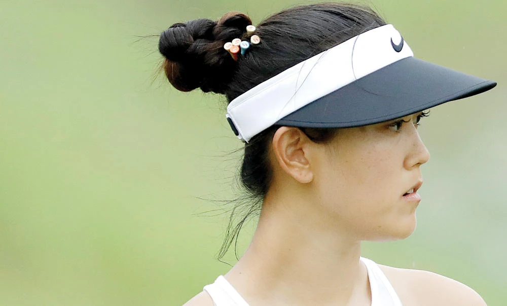 Michelle Wie of the US looks at her ball on the 8th hole during the HSBC Women's Champions golf tournament held at Sentosa Golf Club's Tanjong course on Saturday in Singapore. (AP)