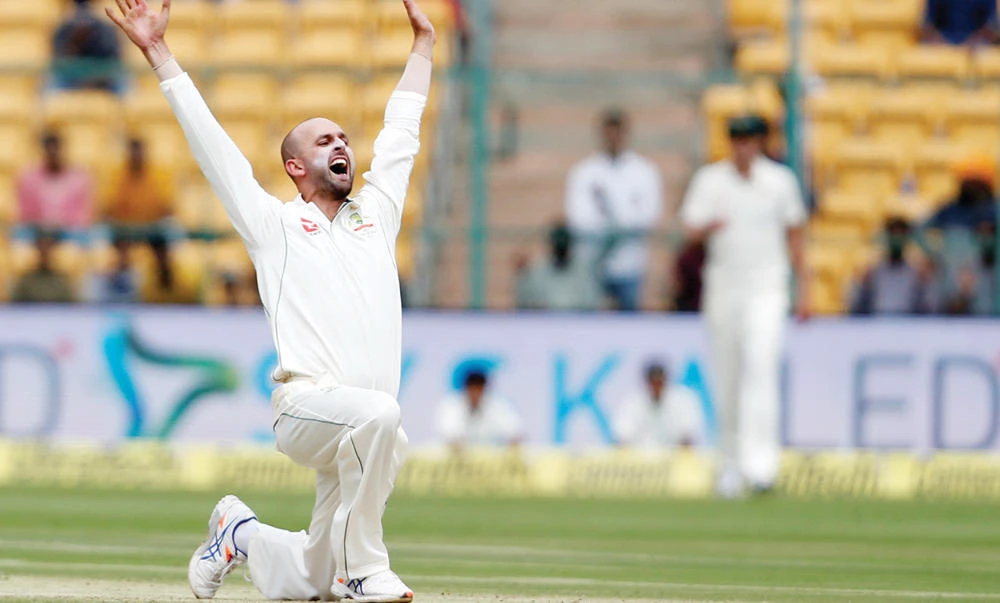 Australia’s Nathan Lyon celebrates the wicket of India’s captain Virat Kohli on Saturday during the India vs. Australia second Test cricket match in Bangalore, India. (Reuters)