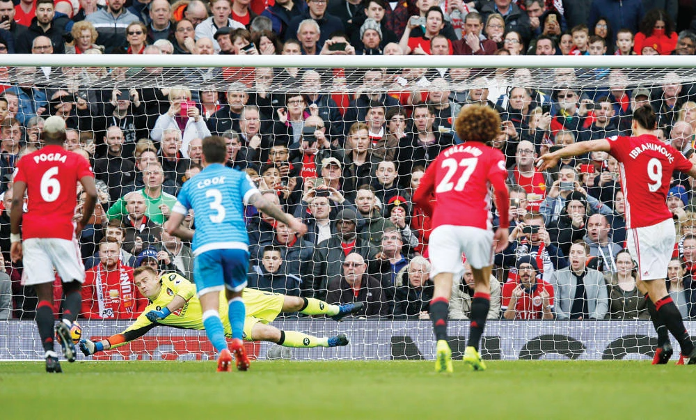 Bournemouth’s Artur Boruc saves a penalty from Manchester United’s Zlatan Ibrahimovic (9) on Saturday in the Premier League match at Old Trafford. (Reuters)