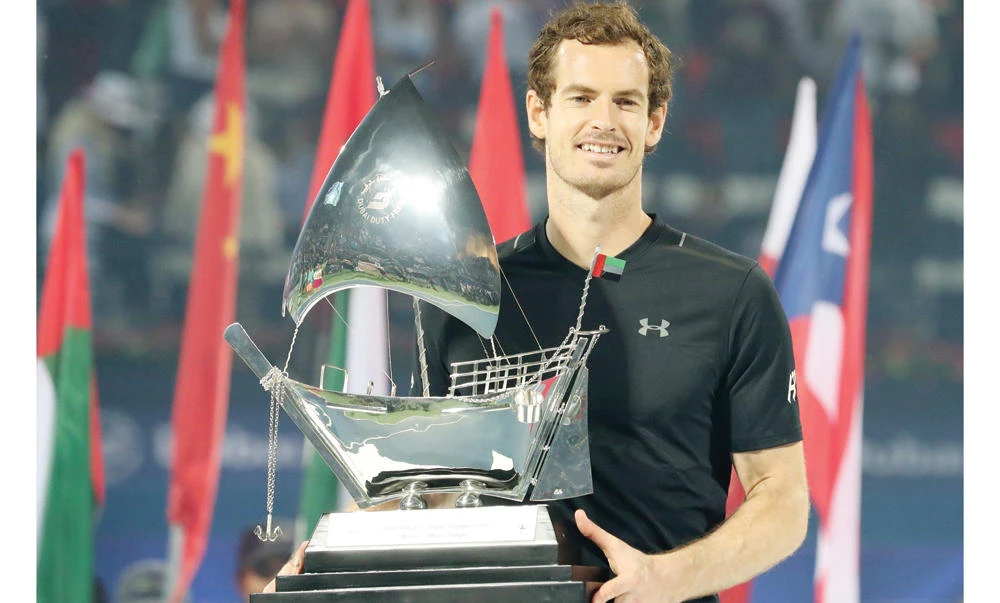 World No. 1 Andy Murray of Great Britain with his championship trophy after winning his ATP final tennis match against Spain's Fernando Verdasco during the Dubai Duty Free Championships on Saturday. (AFP)