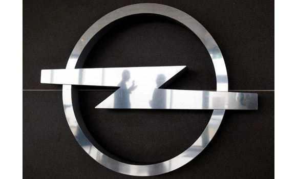Employees at the Opel assembly plant in Antwerp are reflected in an Opel logo, in this February 17, 2009 file photo. (REUTERS)
