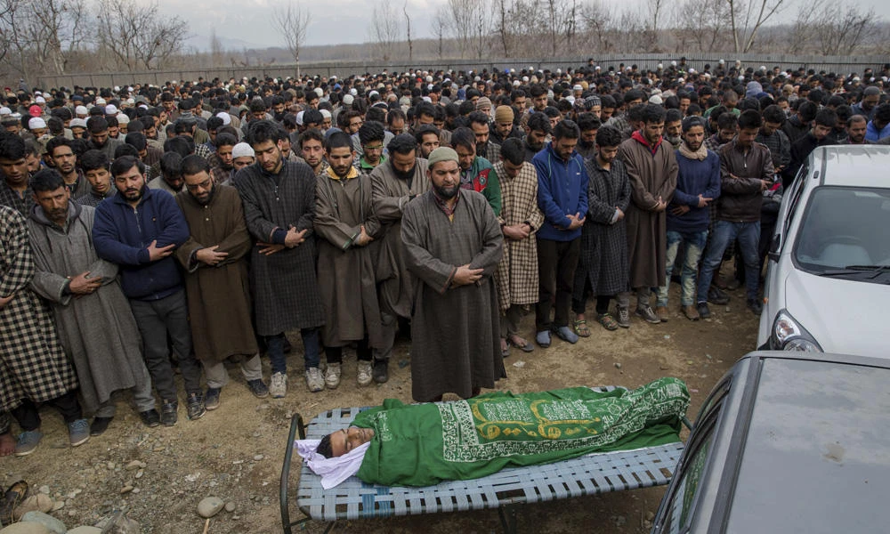 Kashmiri villagers pray by the body of Mohammad Ayoub Wani, a civilian killed in a grenade blast, in Goosu, about 40 kilometers south of Srinagar, Indian controlled Kashmir, on March 3, 2017. (AP Photo/Dar Yasin)