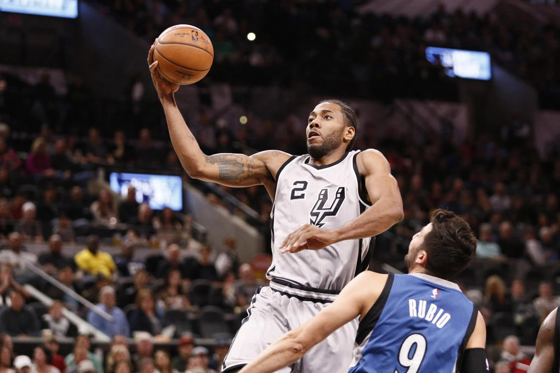 San Antonio Spurs small forward Kawhi Leonard drives to the basket as Minnesota Timberwolves point guard Ricky Rubio defends during the first half of an NBA game at AT&T Center Saturday. (USA TODAY Sports)