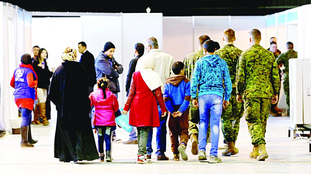 Syrian refugees wait at Marka Airport in Amman, Jordan, to complete their migration procedures to Canada in this file photo. (AP)