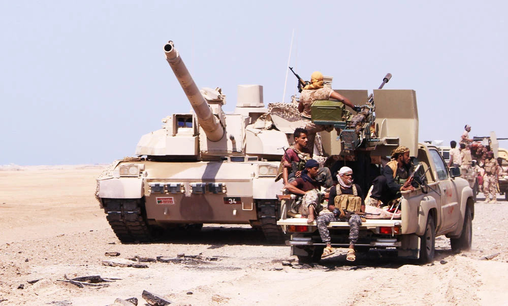 Members of the Yemeni army ride on the back of a military truck near the Red Sea coast city of al-Mokha, Yemen, in this January 23, 2017 photo. (REUTERS)