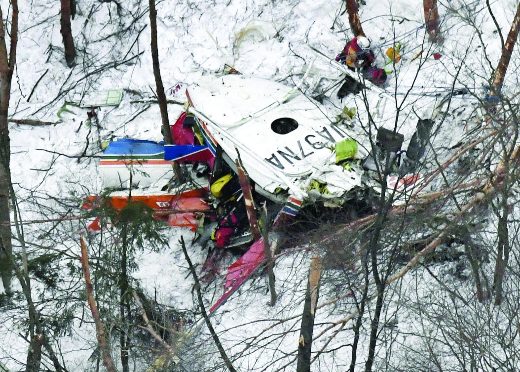 Rescuers work near the helicopter crashed in mountains in Nagano prefecture, central Japan on Sunday. (AP)