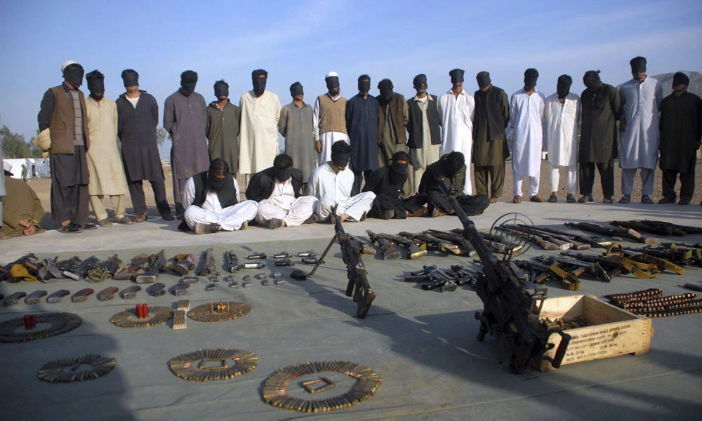 Arrested suspects and recovered weapons display for media by Pakistan paramilitary forces following a search operation in Shah Kass, an area of Pakistani Khyber tribal region along Afghan border, on March 3, 2017. On Sunday night, rebels killed five Pakistani soldiers in the northwestern tribal region of Mohmand, the military said Monday. (AP Photo/Muhammad Sajjad)