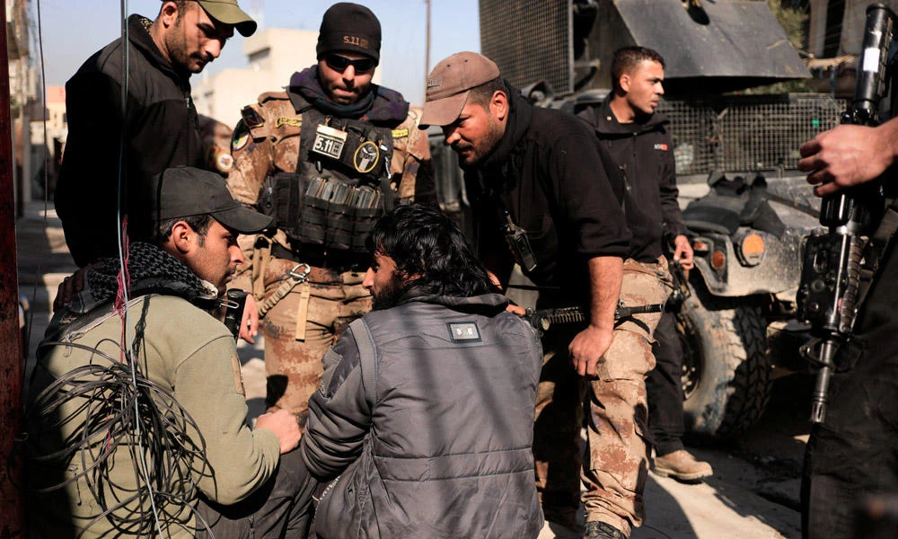 Iraqi special forces members talk to a suspected Daesh militant in Al Mansour district as they advance toward western Mosul on Monday. (REUTERS/Zohra Bensemra)