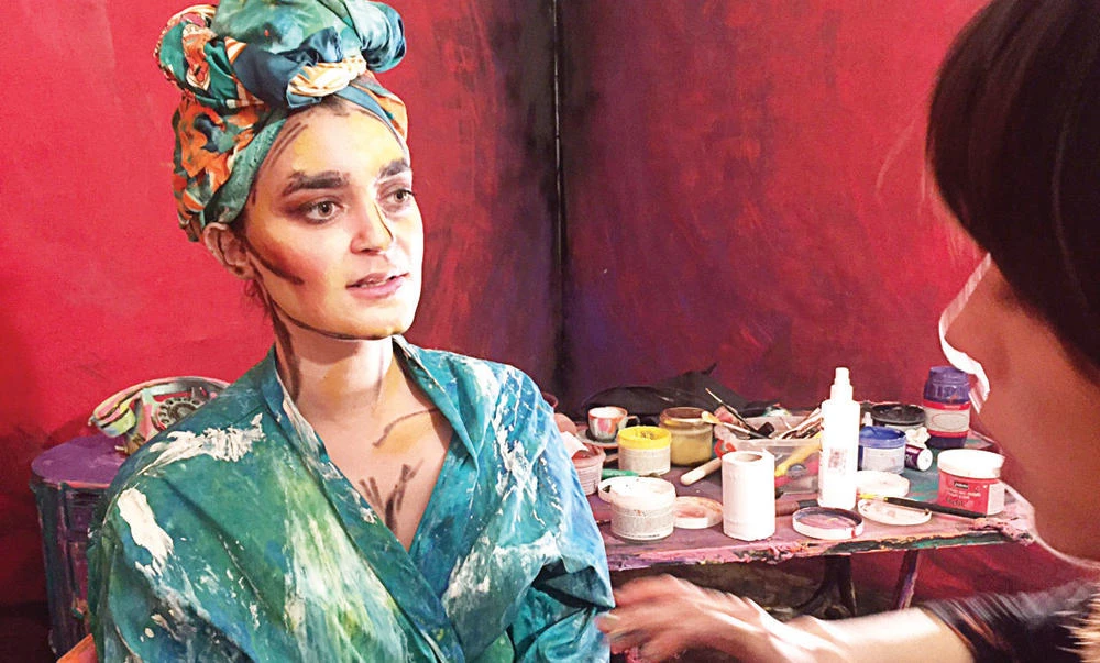 Artist Chanel Arif paints for her art project that uses humans and their surroundings as her canvas, in her gallery in Cairo, Egypt. (Reuters)