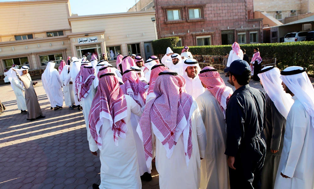Kuwaitis and MPs receive people at MPs Abdullah Al-Barghah residence in Diwaniya, 30 kilometres South of Kuwait City, on Monday, after their Kuwaiti citizenship was reinstated by orders of the Emir of Kuwait. (AFP)
