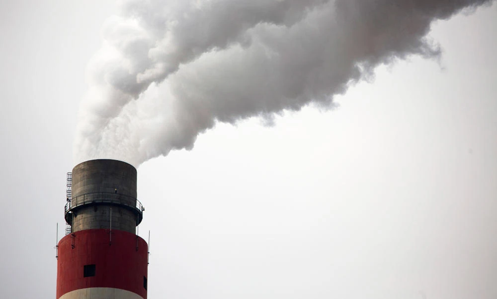 In this Nov. 3, 2015 file photo, smoke and steam rise from the smokestack of a coal-fired power plant near Ordos in northern China's Inner Mongolia Autonomous Region. (AP)