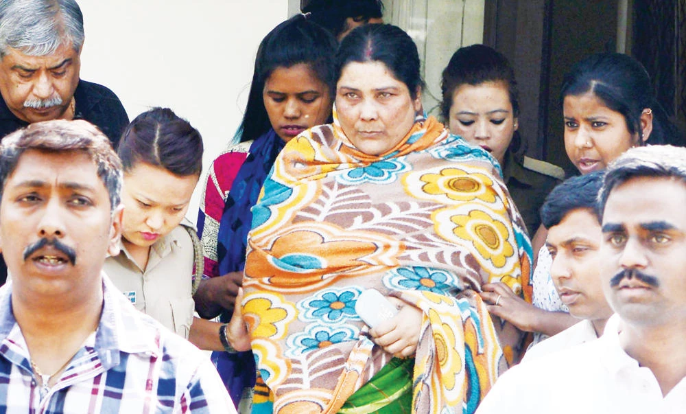 Indian Crime Investigation Department (CID) officials escort Chandana Chakraborty from CID office in Siliguri on March 4, 2017, towards an appearance at a court in Jalpaiguri in the eastern Indian state of West Bengal, after her arrest as part of an alleged child trafficking scandal. (AFP)