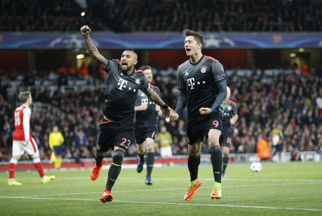 Bayern's Robert Lewandowski celebrates with Arturo Vidal, left, after scoring a penalty. Bayern defeated Arsenal 5-1 on the night. (AP Photo/Frank Augstein)