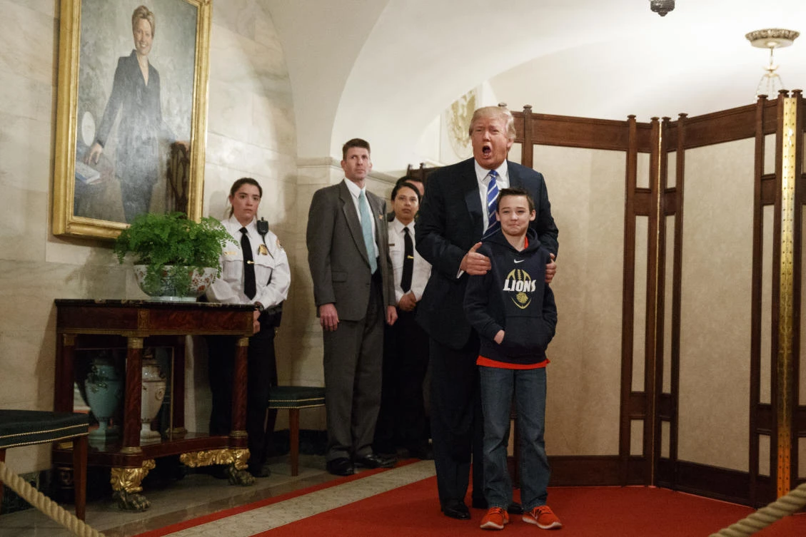 President Donald Trump stands with Jack Cornish, 10, of Birmingham, Alabama as he greets visitors touring the White House in Washington, Tuesday, March 7, 2017. (AP)
