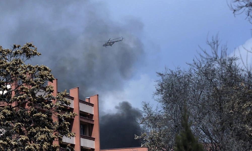 Afghanistan's Army helicopters fly over the biggest military hospital after the clash started between insurgent fighters and army soldiers at the gate of the hospital in Kabul on Wednesday. (AP Photos/Massoud Hossaini)